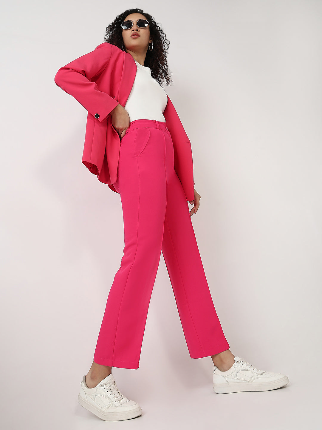 Bold and vibrant hot pink polyester trousers. Tailored for a flattering high-rise fit
